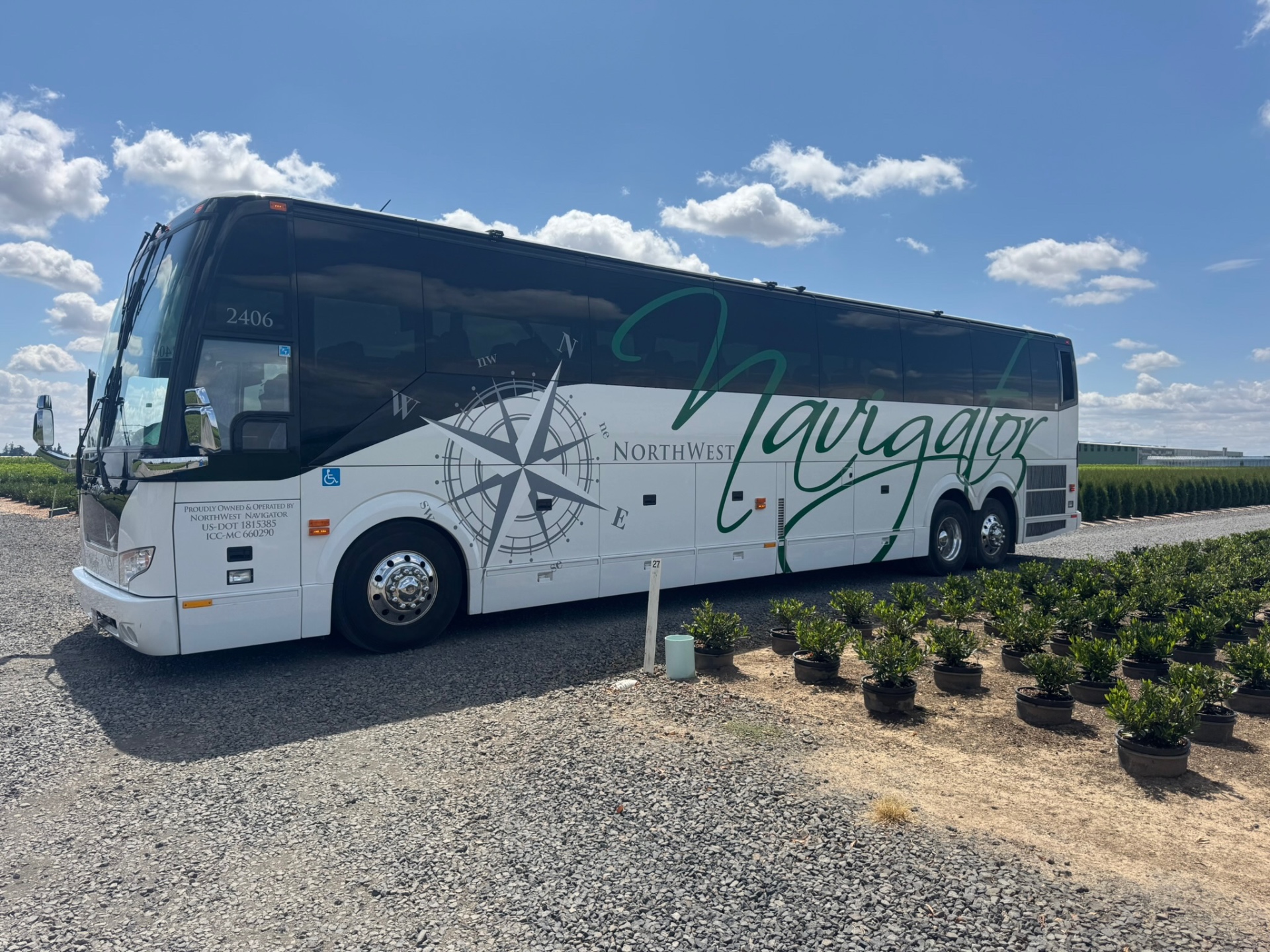 Professional tour bus at agricultural nursery facility during specialized farming tour in USA