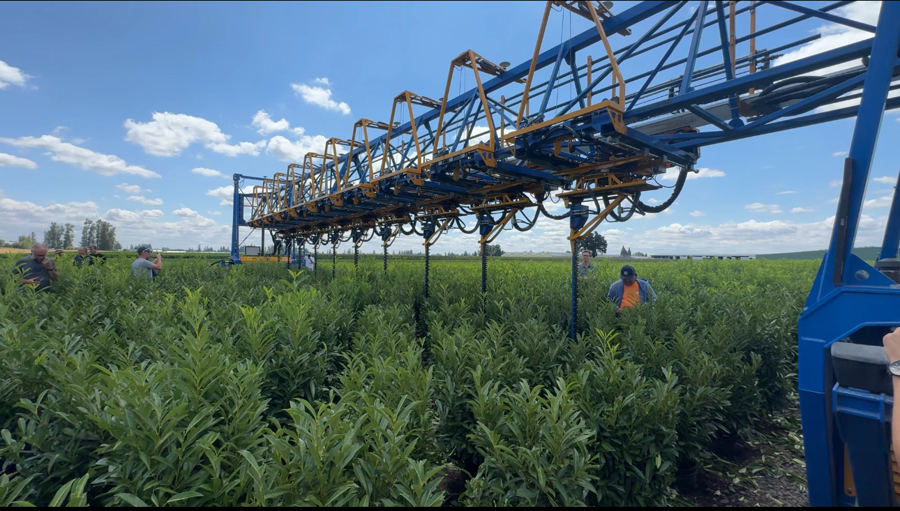 Agricultural spraying equipment operating in fertile crop field showcasing modern farming technology for USA agricultural tours